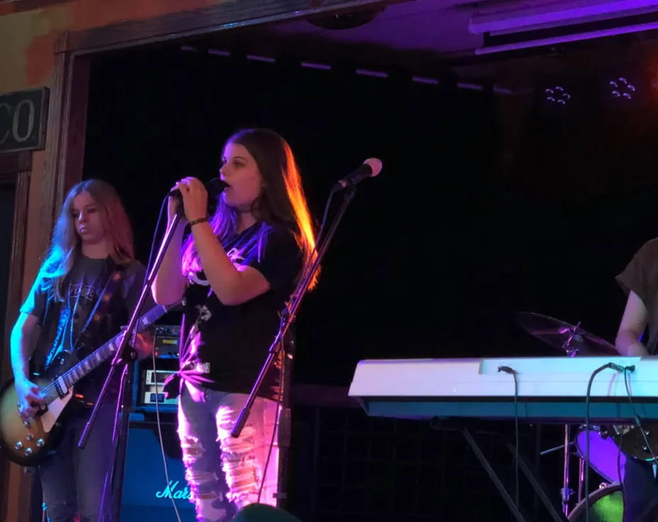 a couple of women singing on stage