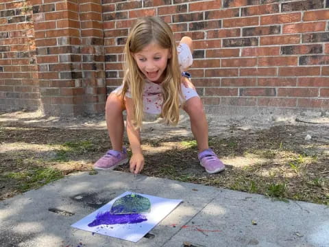 a girl kneeling on the ground