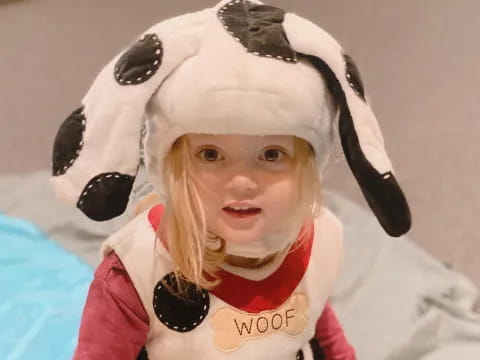 a child wearing a panda hat