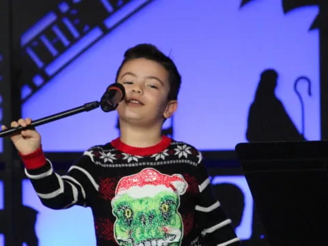 a boy holding a microphone