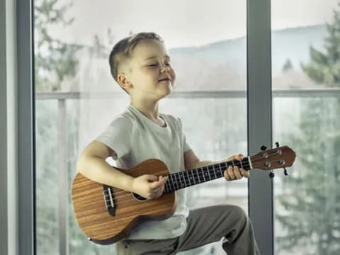 a boy playing a guitar