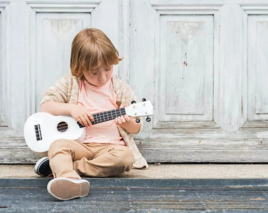 a child playing a guitar