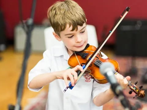 a boy playing a violin