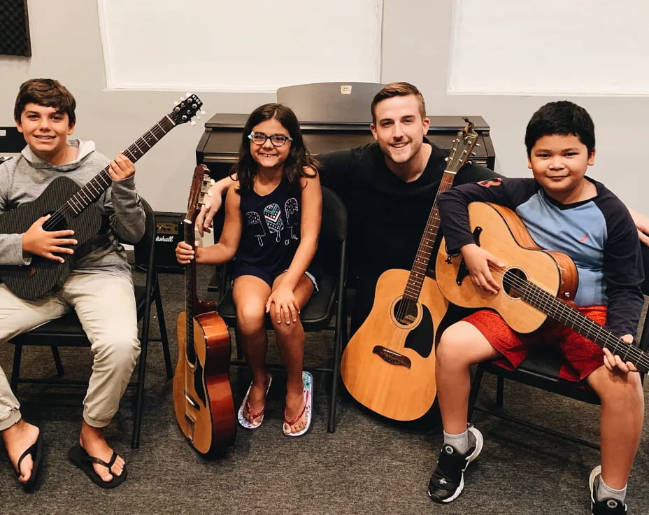 a group of people holding guitars