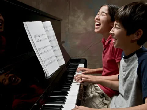 a boy playing a piano