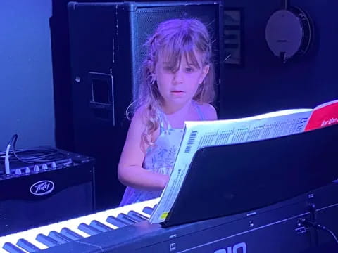 a girl sitting at a computer
