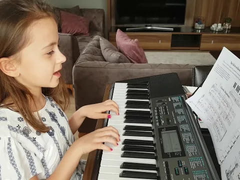 a girl playing a piano