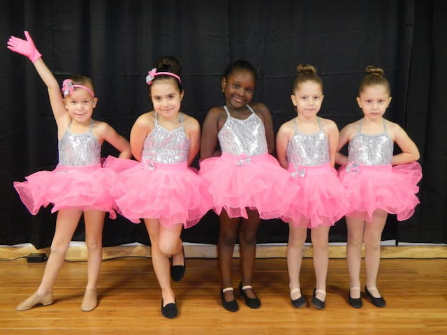 a group of girls in dresses