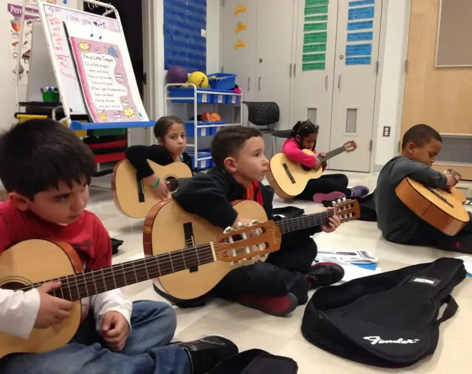 a group of kids playing guitars