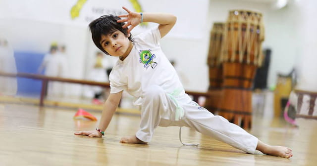 a young girl doing a karate move