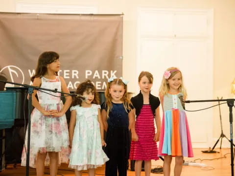 a group of girls in dresses