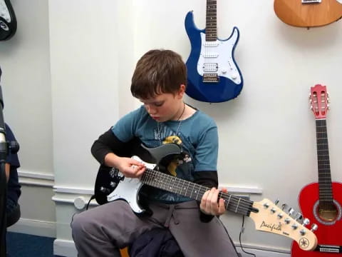 a boy playing a guitar