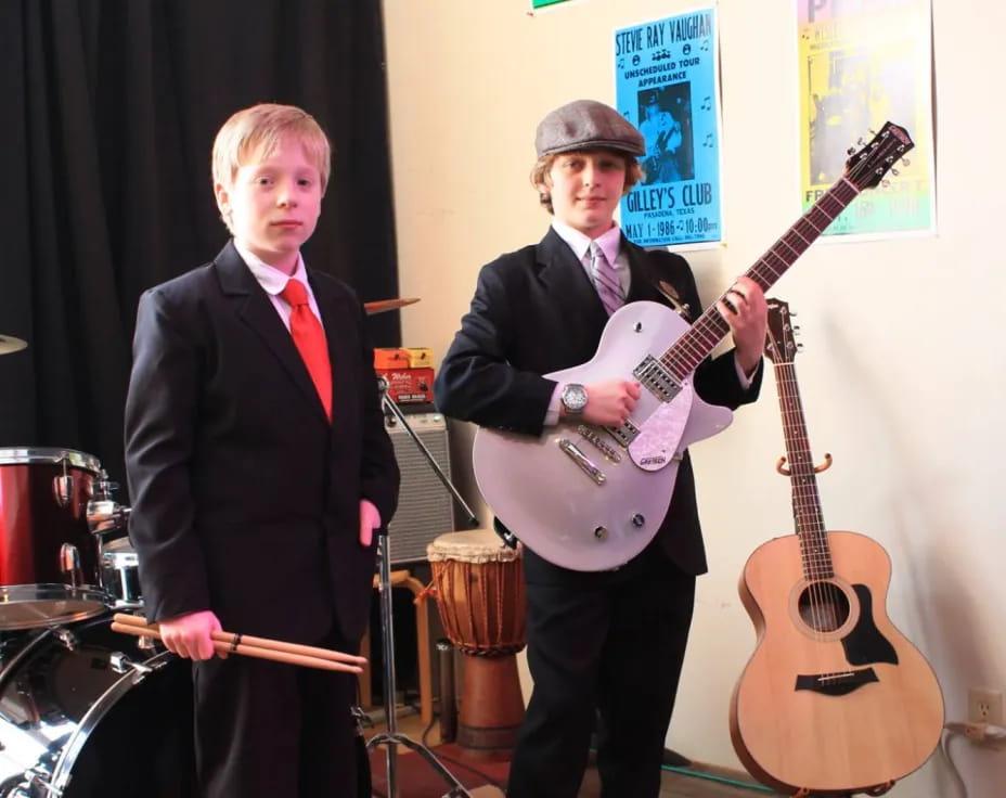 a couple of men holding guitars
