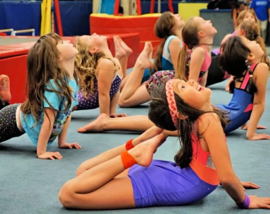 a group of girls doing yoga