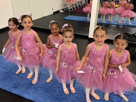 a group of girls in dresses