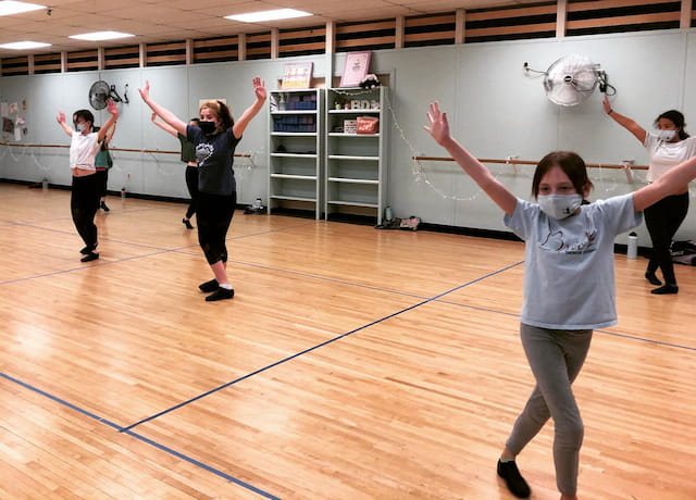 a group of women exercising in a gym
