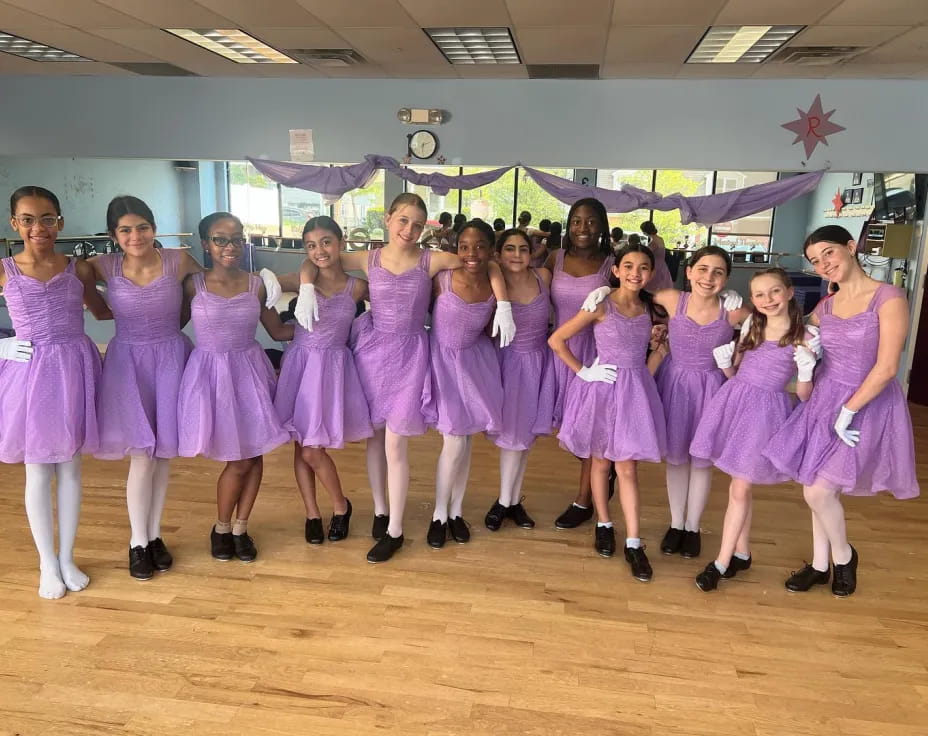 a group of women in purple dresses