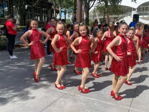 a group of girls in red dresses