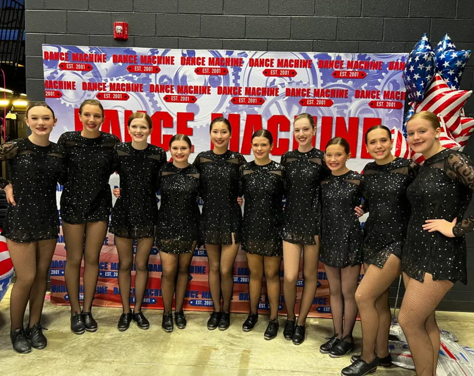 a group of girls in black uniforms