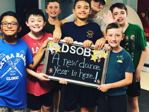a group of boys holding a sign
