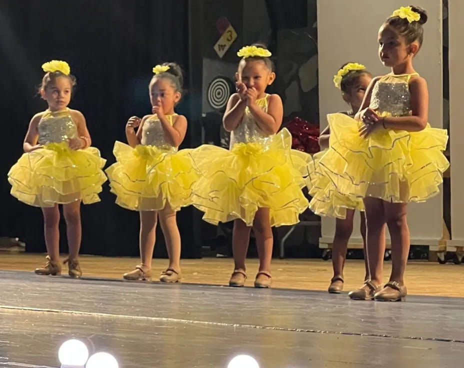 a group of women in yellow dresses