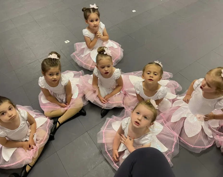 a group of girls in dresses