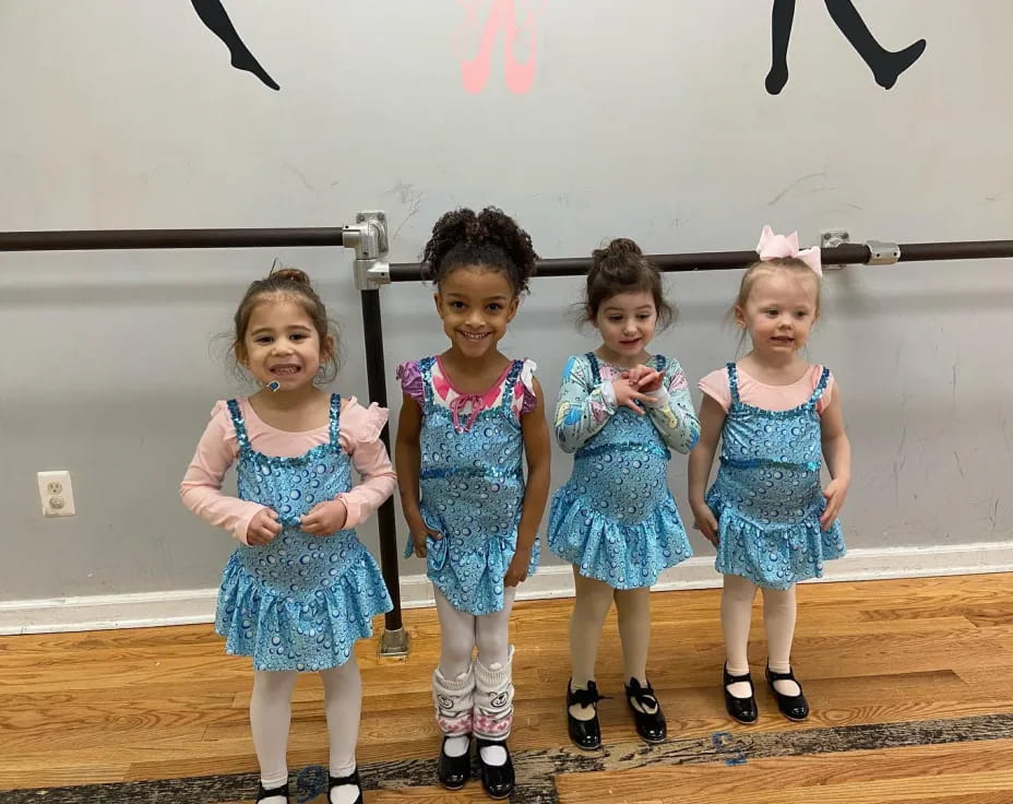 a group of girls in blue dresses