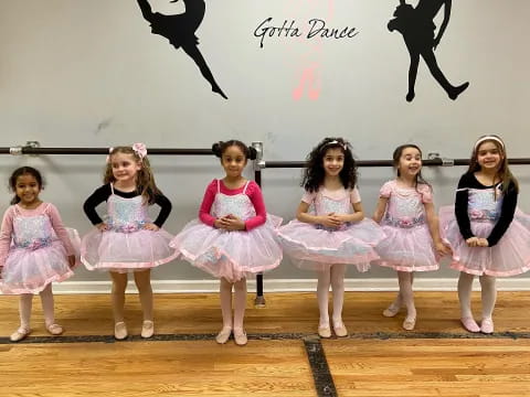 a group of girls in dresses