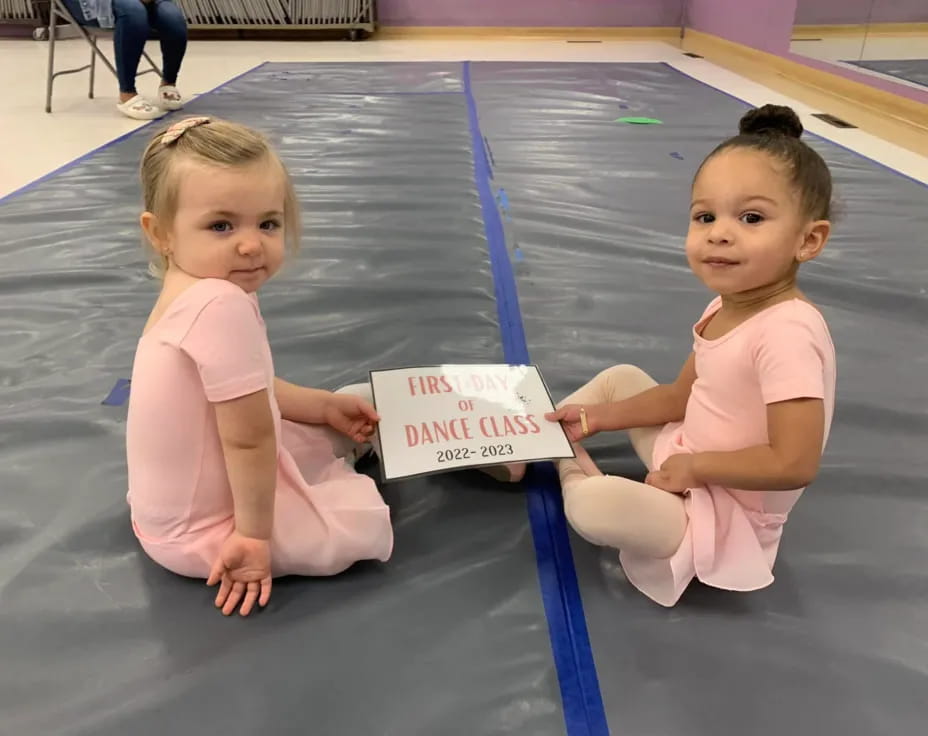 two babies sitting on the floor
