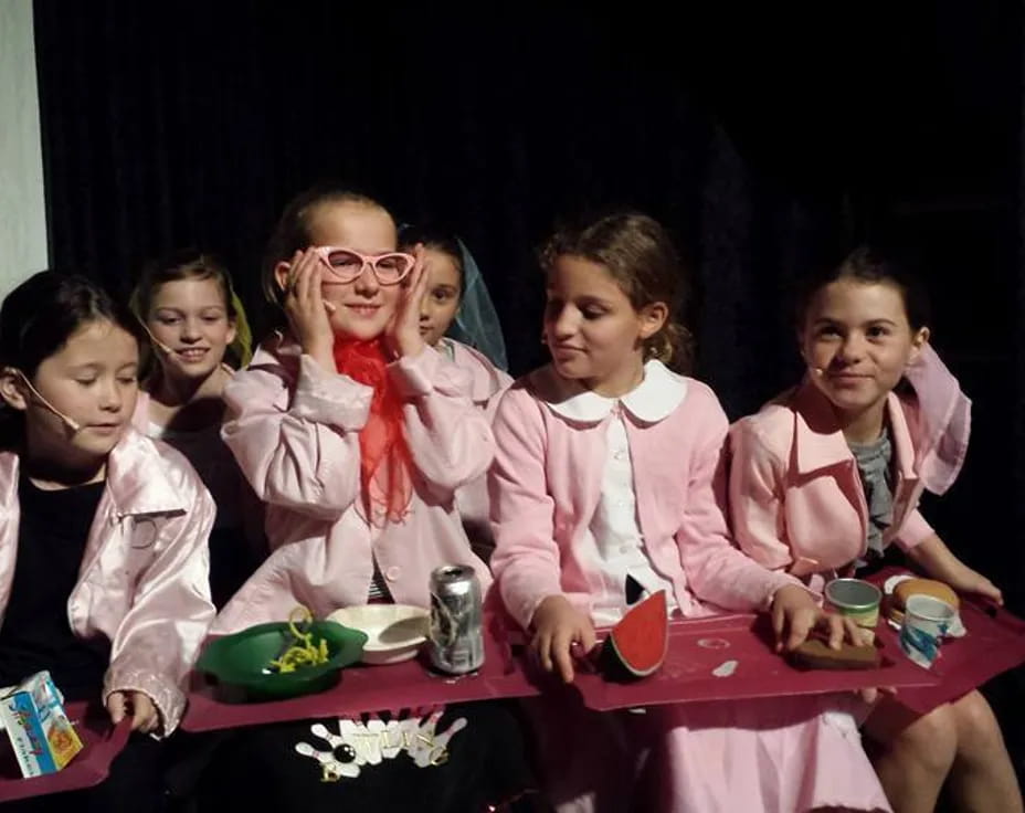 a group of girls sitting at a table