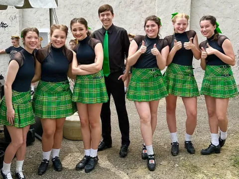 a group of people wearing kilts
