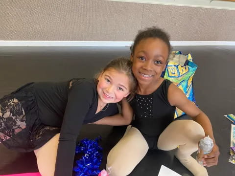 two girls sitting on a couch