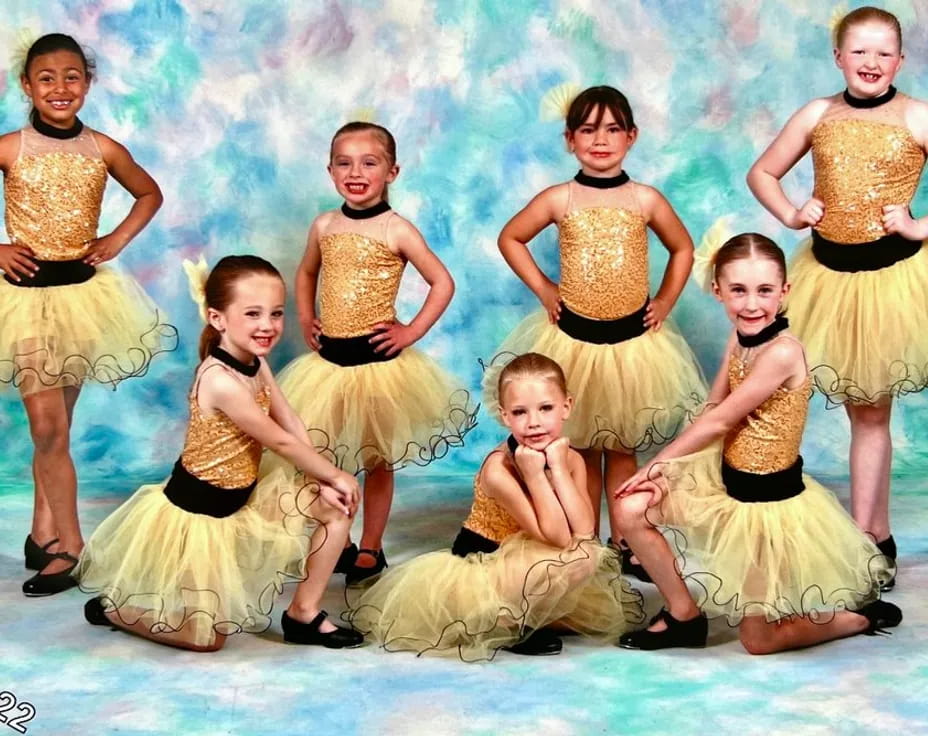 a group of women in yellow dresses