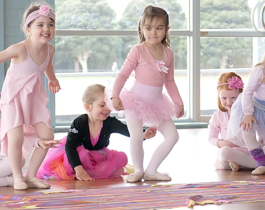 a group of girls in dresses