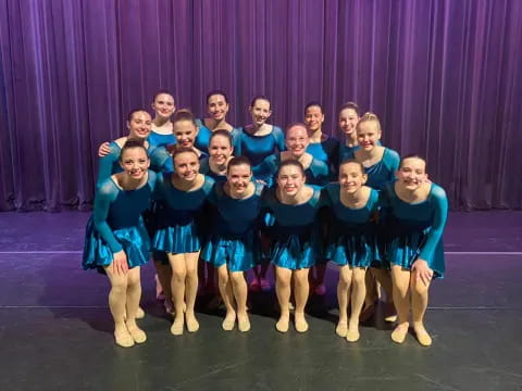 a group of girls in blue dresses