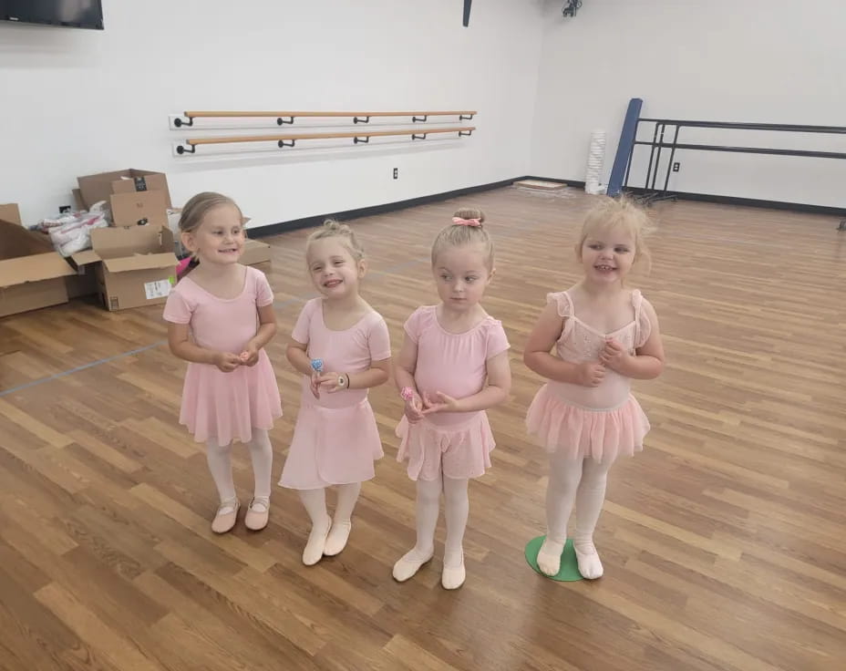 a group of girls in dresses