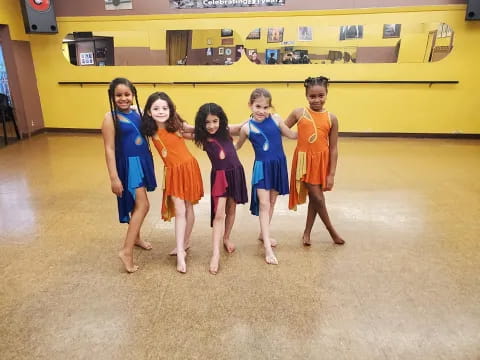 a group of girls in dresses