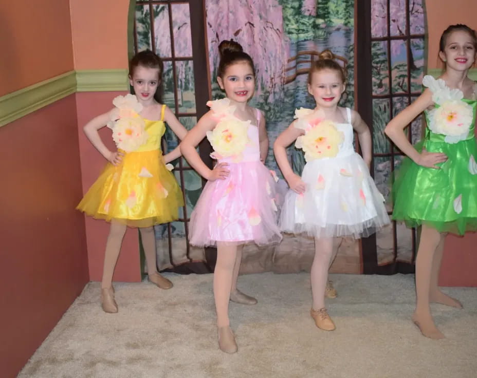 a group of girls in dresses