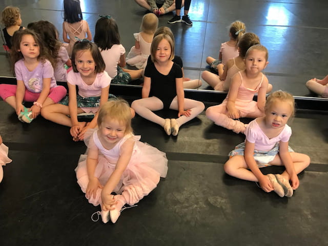 a group of children sitting on the floor