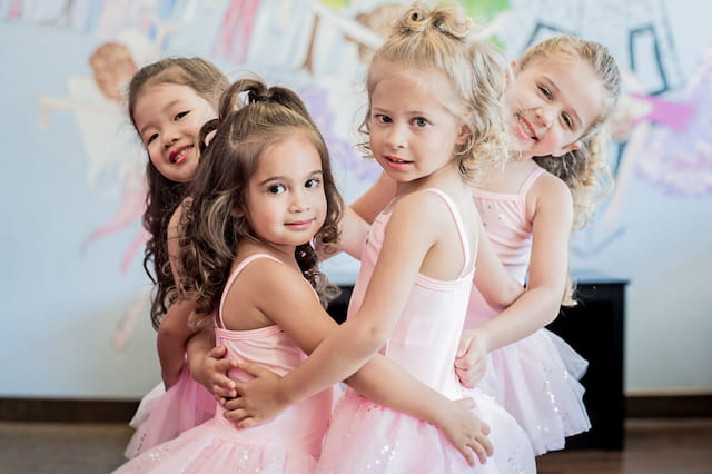 a group of girls in dresses