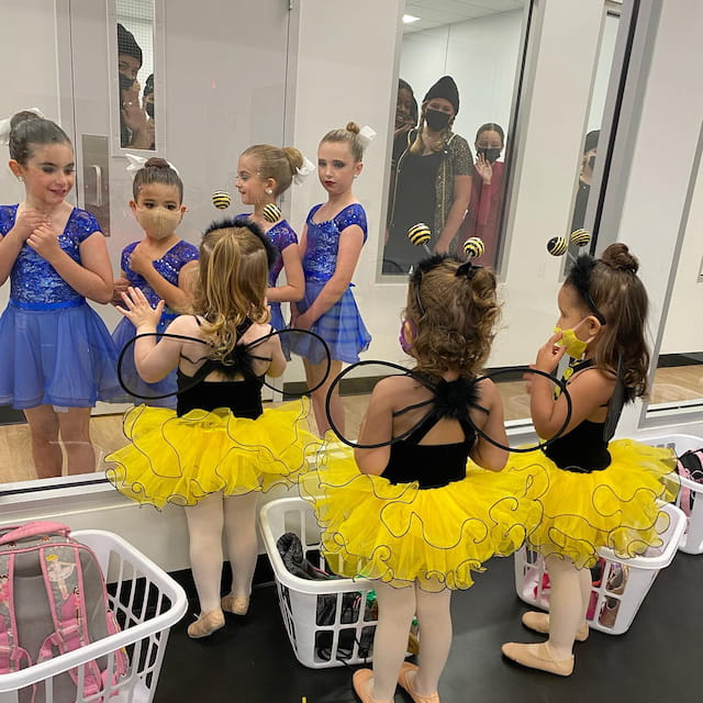 a group of girls in dresses