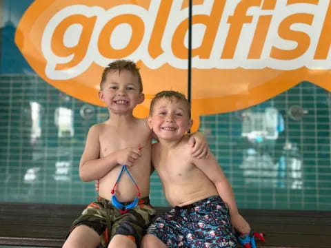 two boys sitting on a bench