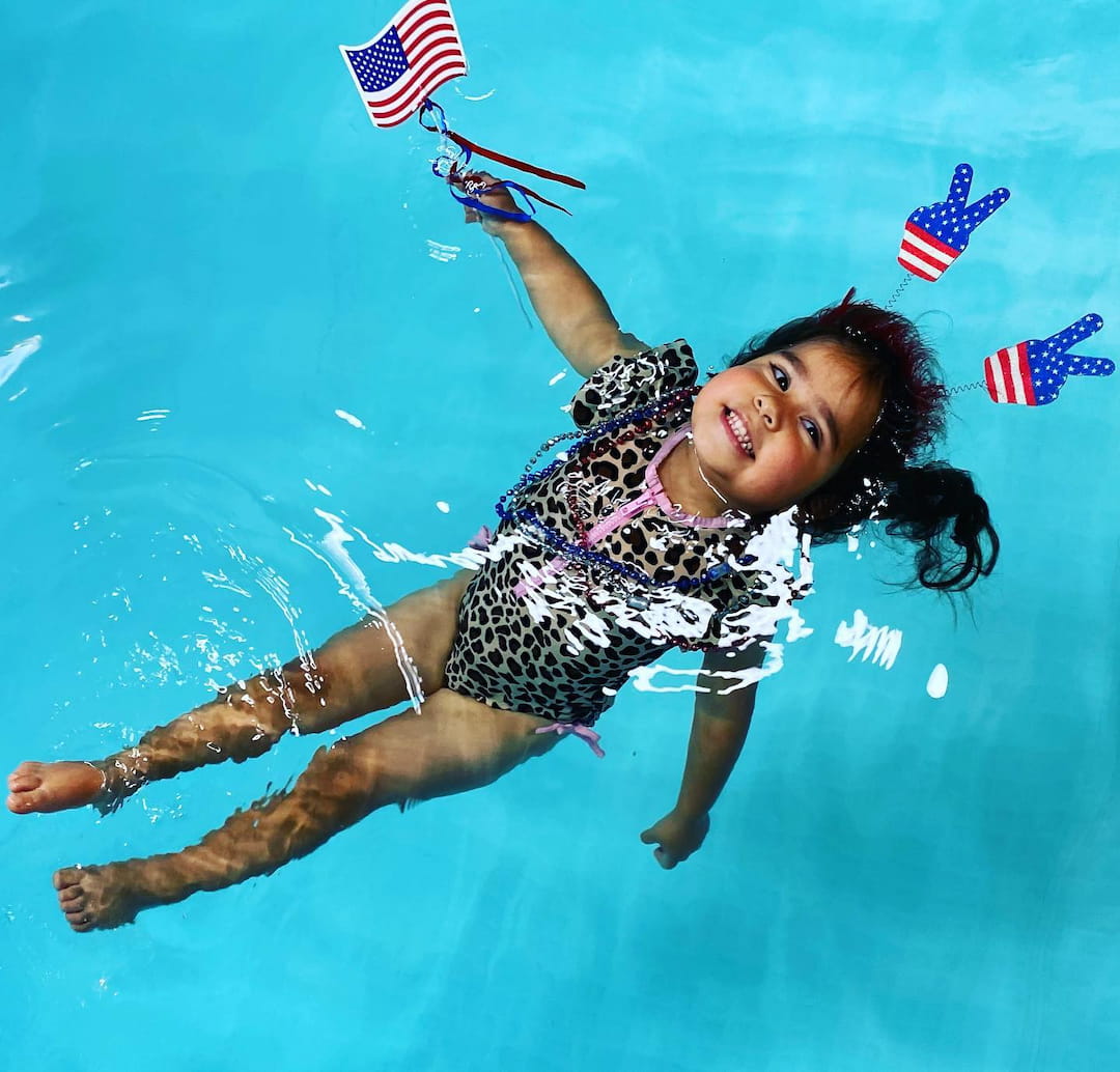 a person in a swimsuit jumping into the water