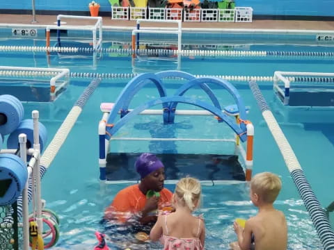 a group of kids playing in a pool