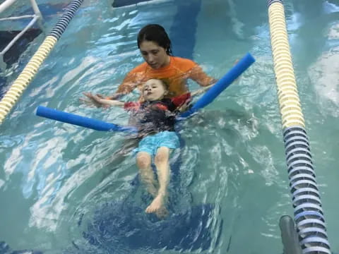 a man and a baby in a pool