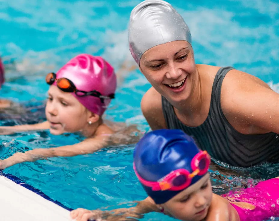 a person and two children in a pool