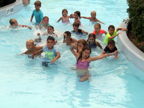 a group of children in a pool