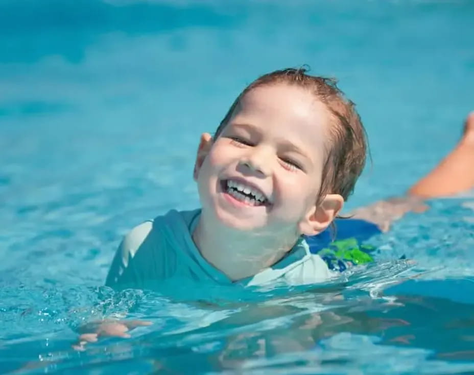a boy swimming in water