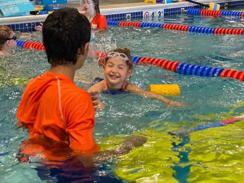 a man and a child in a pool