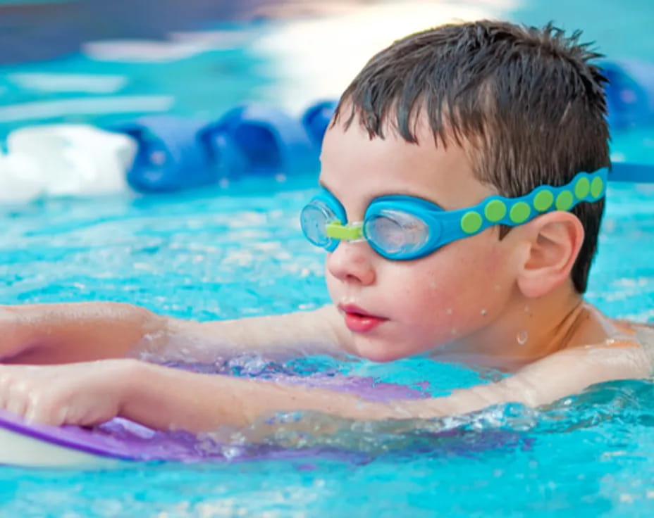 a baby wearing goggles in a pool